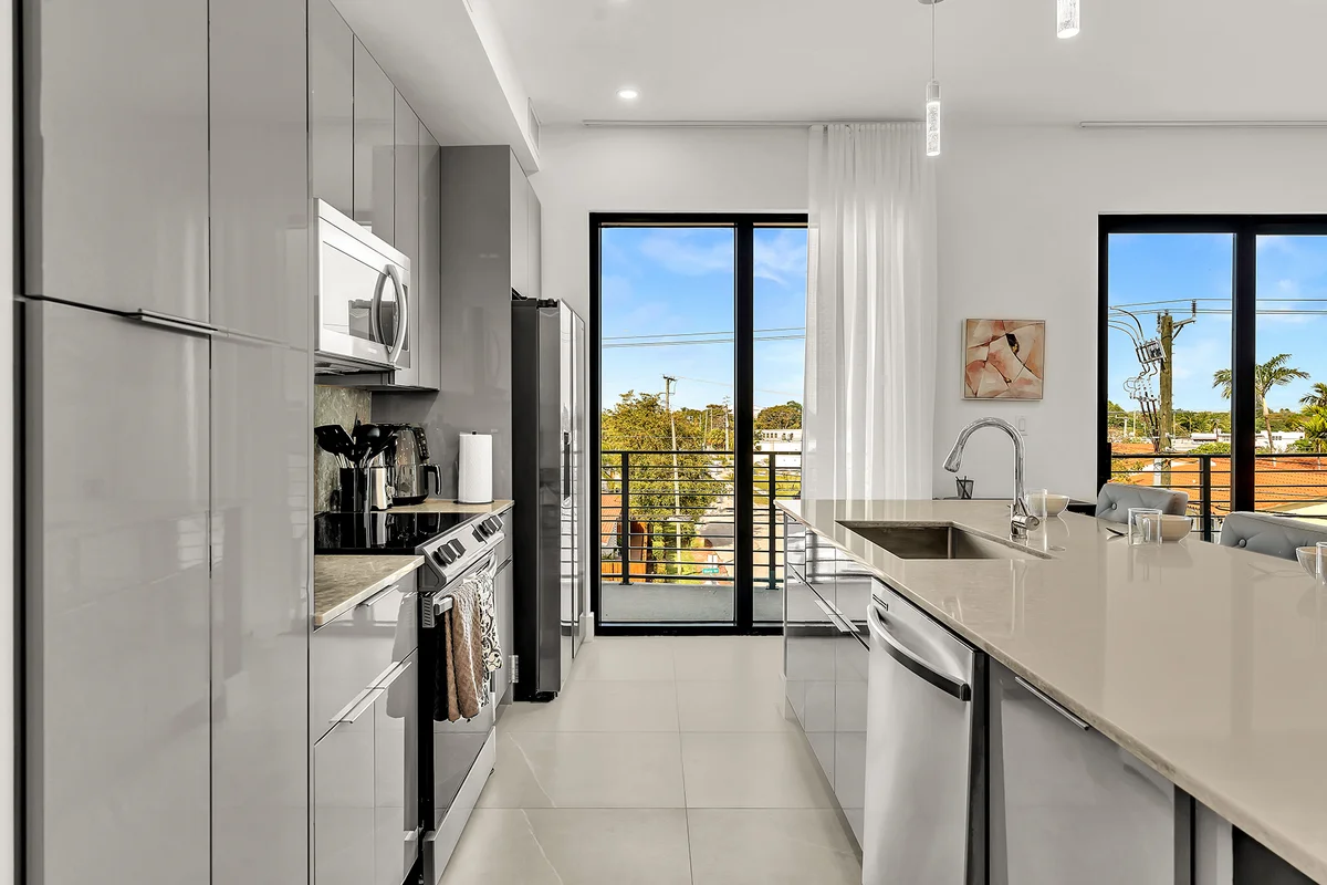 Modern luxury kitchen with floor-to-ceiling windows and city views