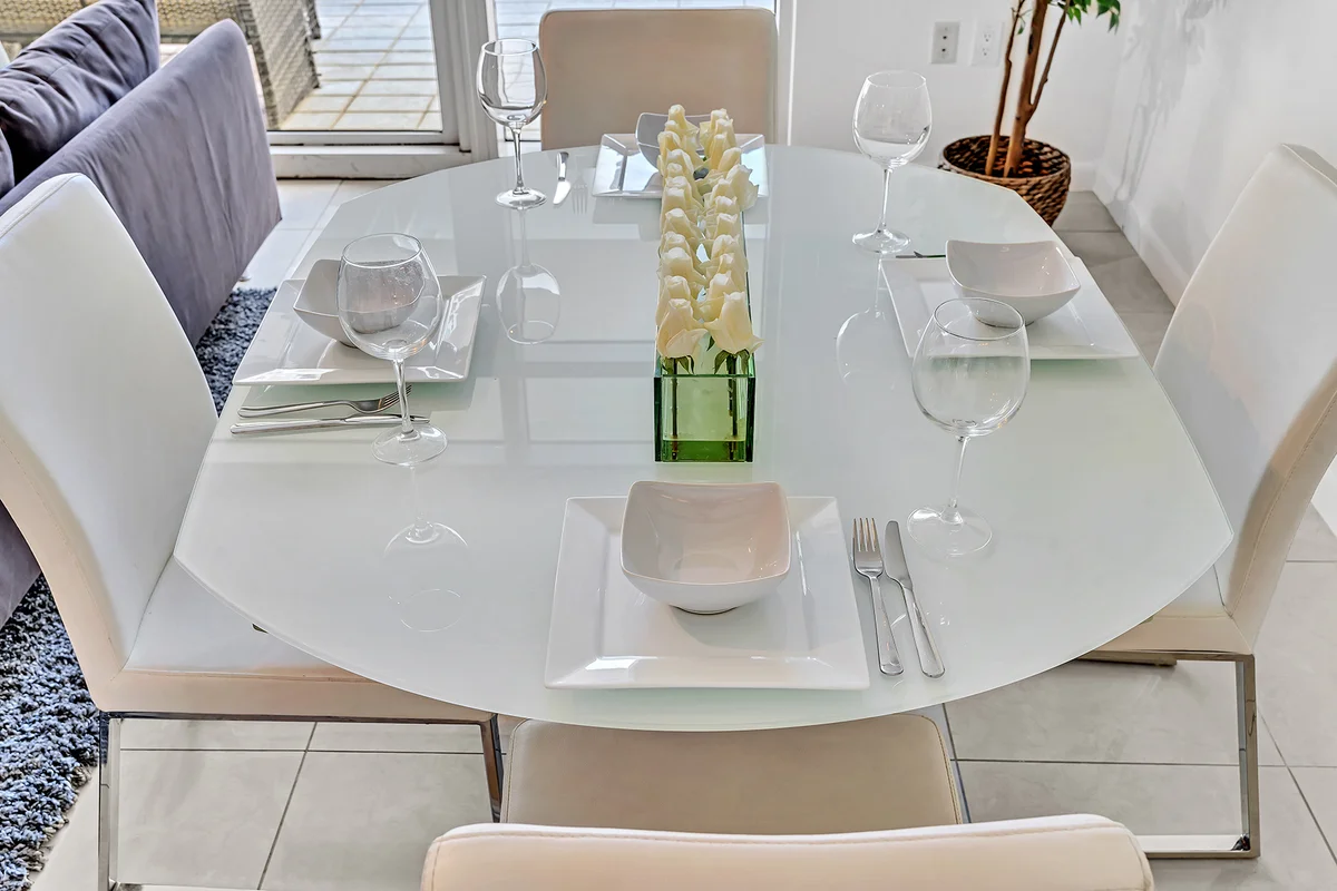 3L Management Group property manager reviewing Coral Gables luxury rental listing performance data on a tablet