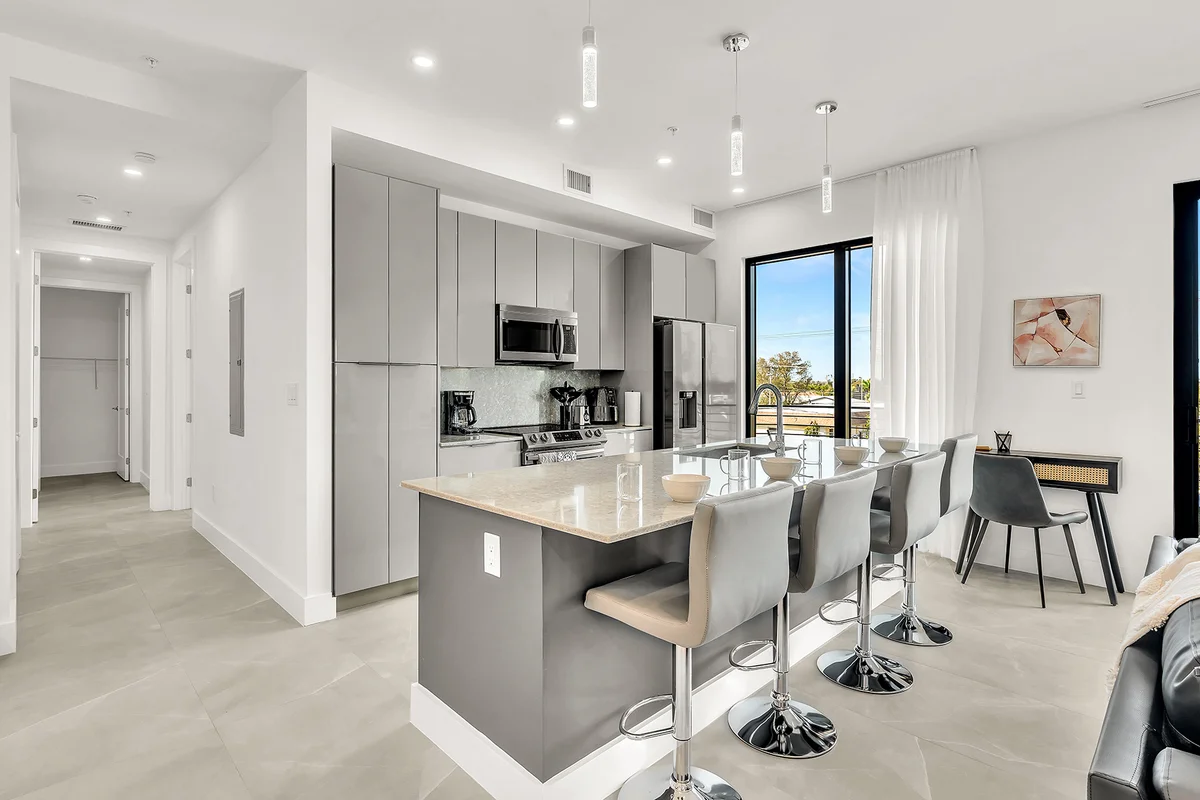Modern open-concept kitchen with island seating and dining area