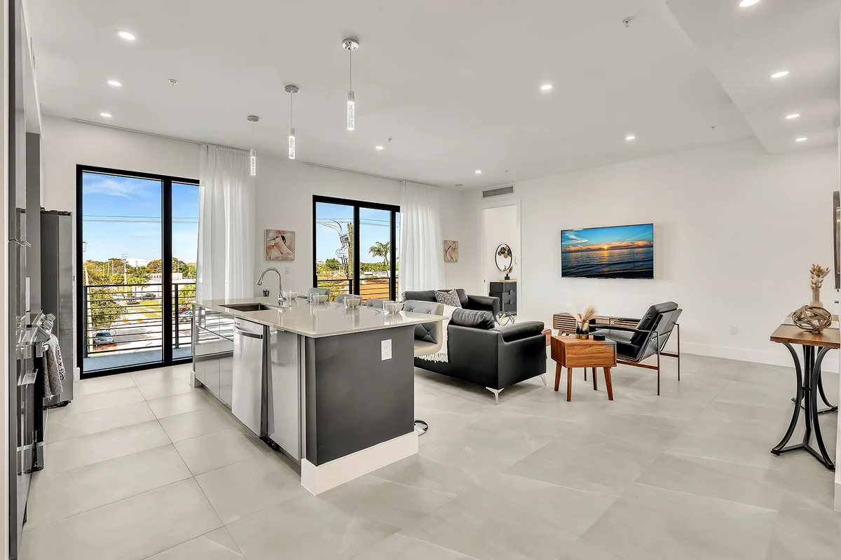 Modern open-concept kitchen and living room with city views